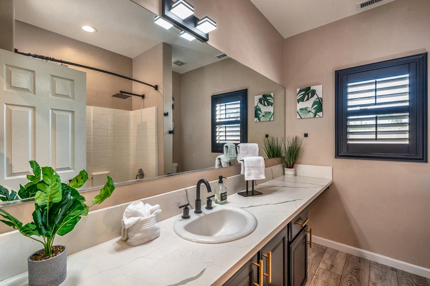 Hall bathroom with quartz counter and plantation shutters