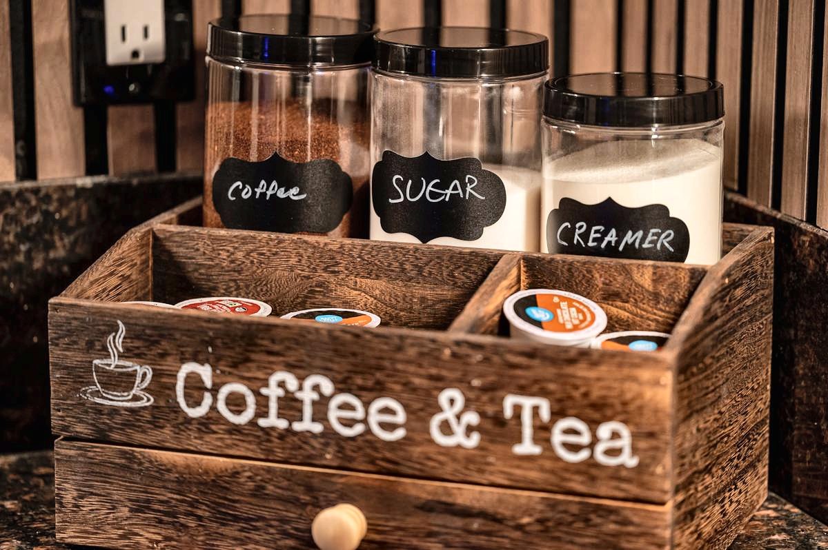 Coffee and tea station with Keurig pods, ground coffee, sugar and creamer
