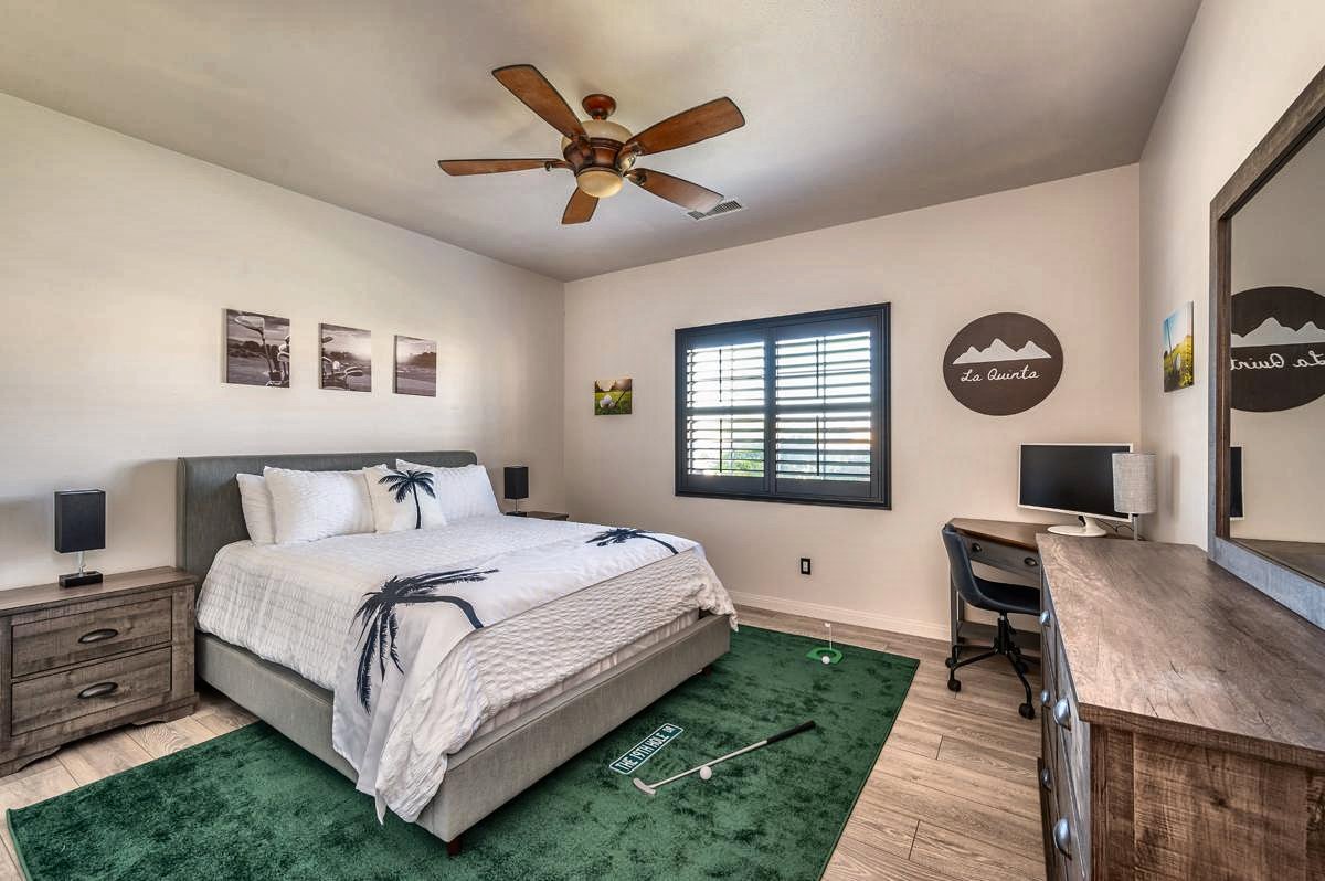 La Quinta golf room with king-size bed, putting green rug, desk and dresser