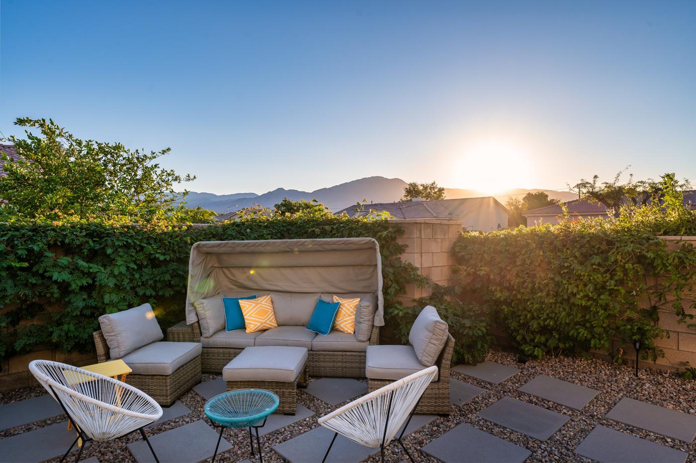 Canopy daybed and chairs facing the Santa Rosa Mountains at sunset
